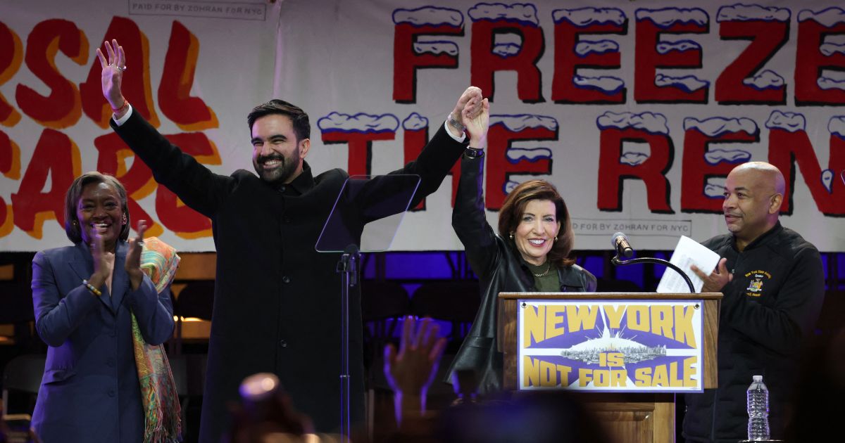 New York City Mayor-elect Zohran Mamdani holds hands with New York Gov. Kathy Hochul on stage during a campaign rally at Forest Hills Stadium in the Queens borough of New York City on Oct. 26, 2025.