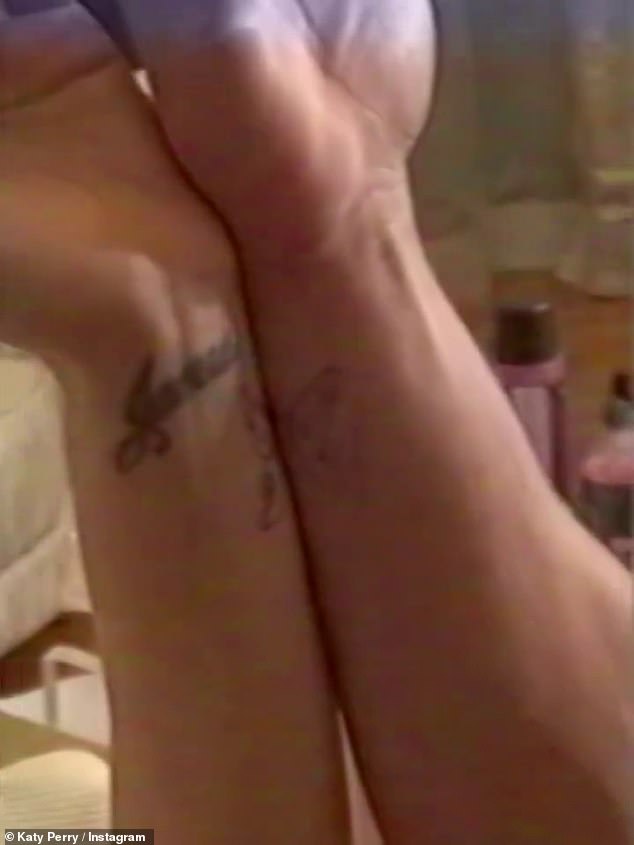 In the clip Katy showed off half a butterfly on her wrist, before another arm came into view with matching artwork to make the insect whole