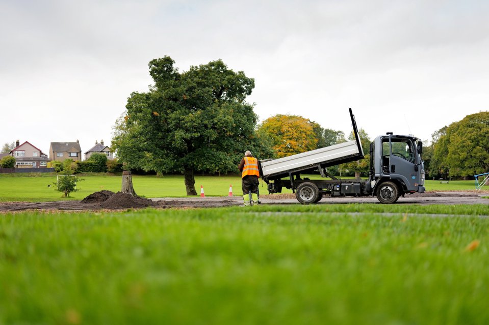 A construction worker next to a dump truck in Chapel-en-le-Frith Memorial Park, where a multi-use games area (MUGA) is being demolished.