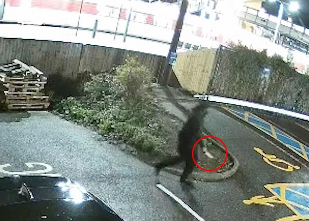 Chilling: The black-clad man holding a knife strolls away from the train after causing carnage. Sources confirmed that the suspect had a history of mental-health issues and was known to the authorities previously