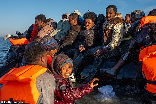 Migrants board a small boat into the English Channel in August. Britain has continued to face challenges with mass illegal migration