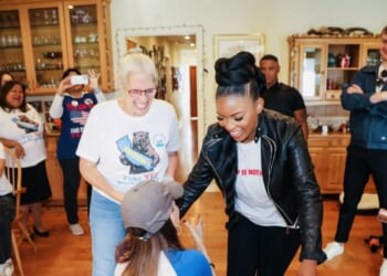 Stephanie Miller greets Texas Democratic Rep. Jasmine Crockett’s feet at an event.