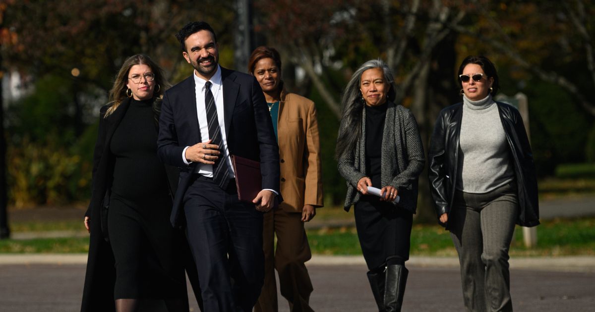 Mayor-elect of New York City Zohran Mamdani stands next to members of his transition team in the Queens borough of New York City on Nov. 5, 2025.