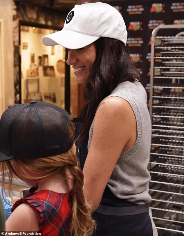 Lilibet's braided red hair was shown in rare photos from the family's volunteering day in Los Angeles