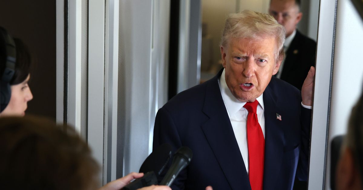 President Donald Trump speaks to members of the media on board Air Force One on Oct. 31, 2025, at Joint Base Andrews, Maryland.