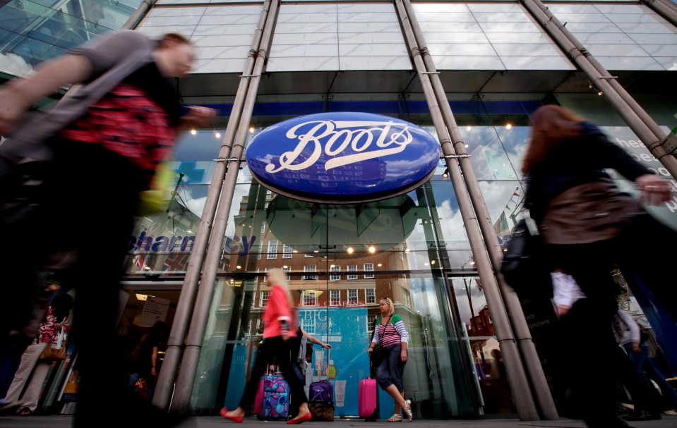 Pedestrians walking past a Boots store in London.