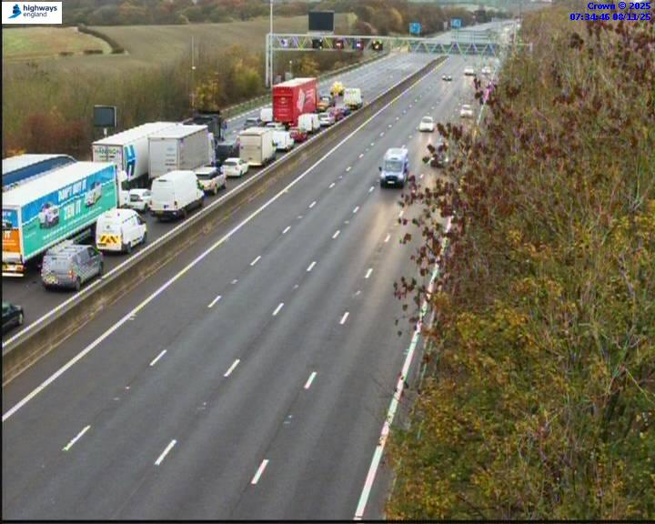 Traffic jam on the left lanes of a multi-lane highway, with cars moving on the right lanes.