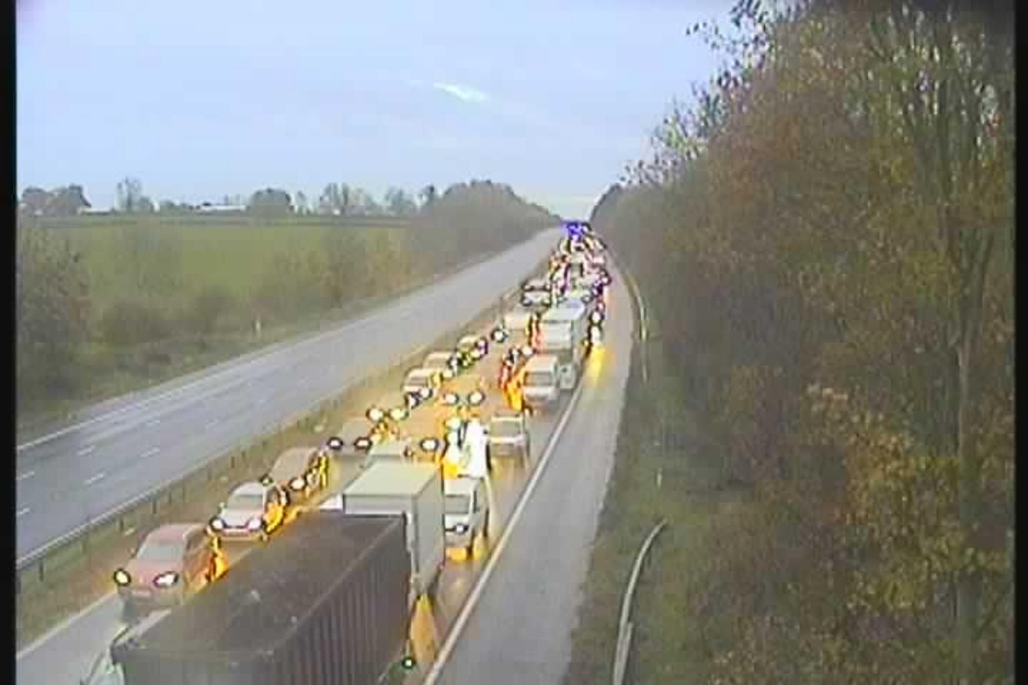 An image collage containing 1 images, Image 1 shows Heavy traffic on a highway in overcast weather