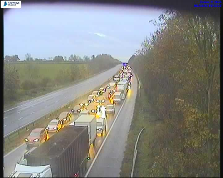 Heavy traffic on a highway in overcast weather.