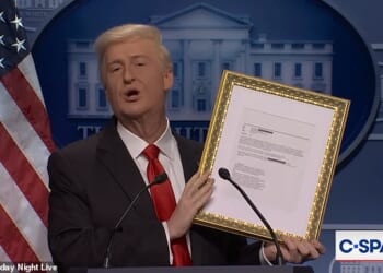 Donald Trump, played by James Austin Johnson, held up a framed Jeffrey Epstein email mentioning him