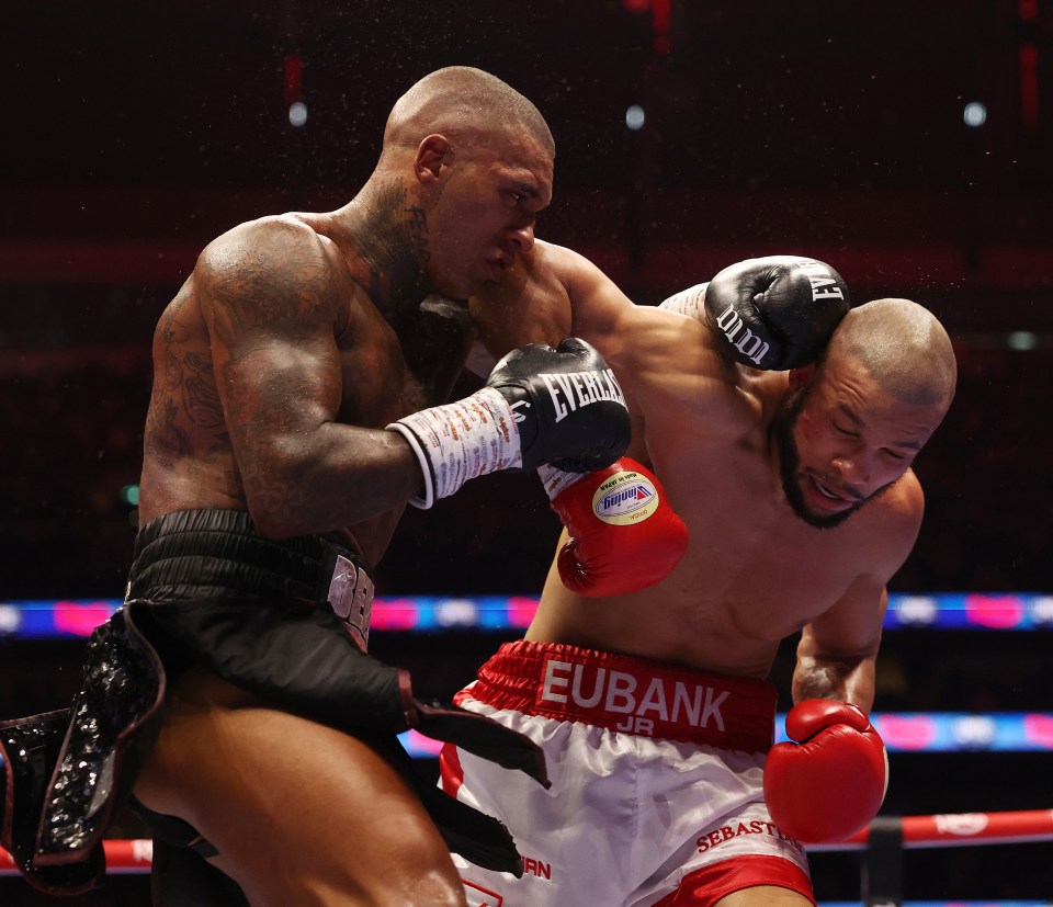 Conor Benn, in black shorts, punches Chris Eubank Jr., in white shorts, during their Middleweight contest.
