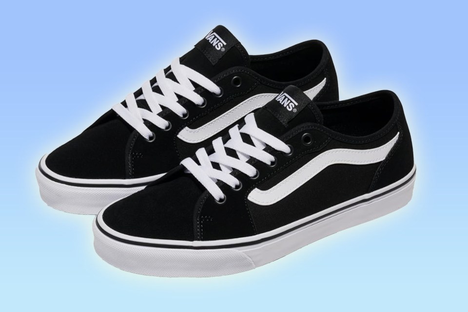 Two black Vans sneakers with white laces and side stripes.