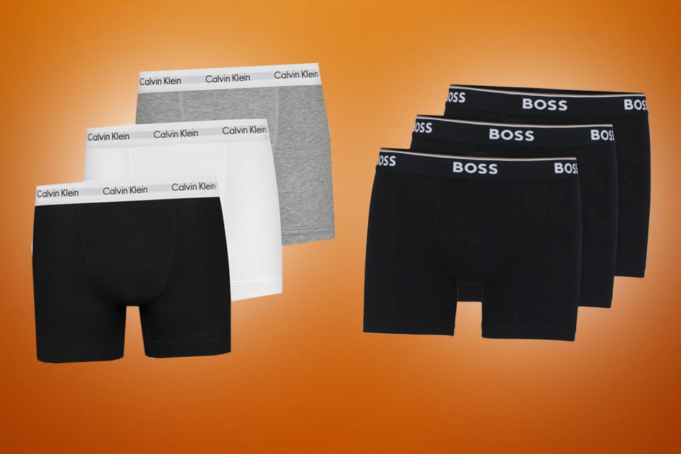 Three pairs of Calvin Klein boxers in black, white, and grey, and three pairs of black BOSS boxers.