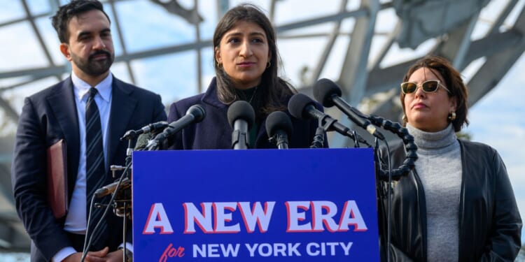 Lina Khan, center, speaks during a news conference Wednesday in the Queens borough of New York City. Mayor-elect Zohran Mamdani, left, named Khan co-chair of his transition team.