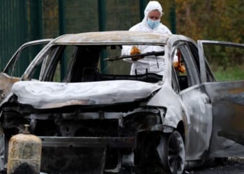 The car used by a man to run down pedestrians before he set it on fire and ran away on the French island of Ile d'Oleron is processed by authorities on Wednesday.
