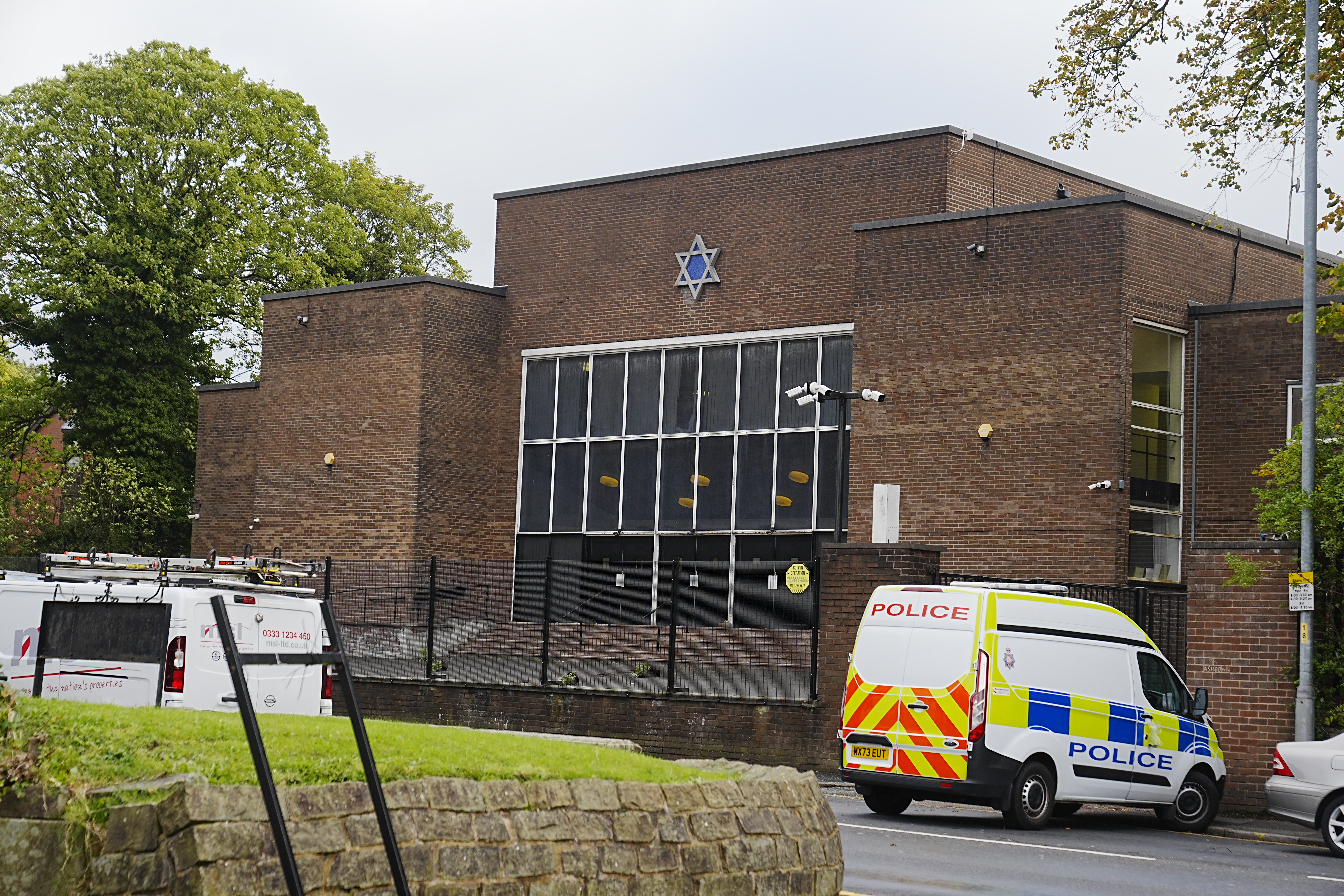 Heaton Park Hebrew Congregation synagogue in Manchester, with a police van parked outside.