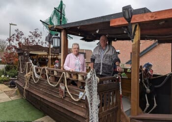 Despite being a neighbourhood favourite in the village of Horndean at Halloween , the installation has also attracted local anger due to 'the number of visitors and the local impact'. Pictured: Steve and Lynnette Coombs with their self built pirate ship