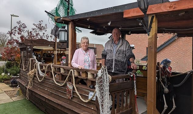 Despite being a neighbourhood favourite in the village of Horndean at Halloween , the installation has also attracted local anger due to 'the number of visitors and the local impact'. Pictured: Steve and Lynnette Coombs with their self built pirate ship