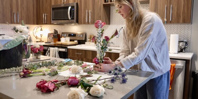Megan Feller arranges bouquets for a party at her apartment in Edina, Minnesota.