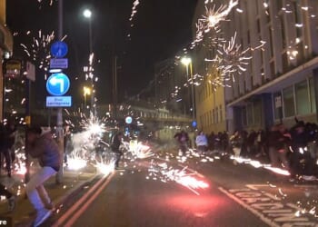 Footage shows fireworks being set off in the city centre as police battle to regain control amidst scenes of chaos and disruption