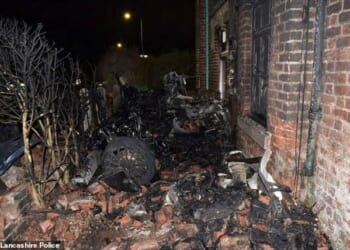 Zachary Hocking, 28, was driving a McLaren 570GT V8 at an average speed of 91mph in a 30mph zone when he lost control and ploughed into the property in the seaside town of Lytham St Annes, Lancashire. Pictured: The blackened remains of supercar lie amid piles of bricks dislodged in the crash