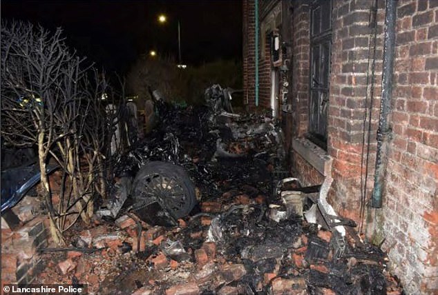 Zachary Hocking, 28, was driving a McLaren 570GT V8 at an average speed of 91mph in a 30mph zone when he lost control and ploughed into the property in the seaside town of Lytham St Annes, Lancashire. Pictured: The blackened remains of supercar lie amid piles of bricks dislodged in the crash