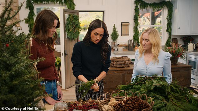 While creating a wreath, Meghan paired a £250 Dôen spotty midi skirt with a £530 Co cashmere sweater for a cosy chic ensemble