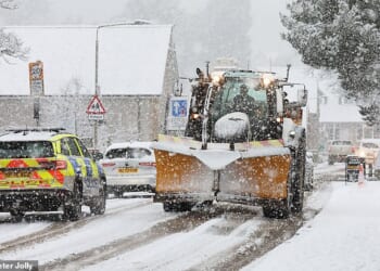 Traffic battles though as heavy snow falls at Kingussie in the Scottish Highlands this morning