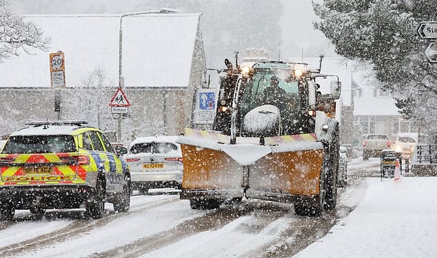 Traffic battles though as heavy snow falls at Kingussie in the Scottish Highlands this morning