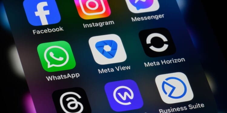 A phone screen displays a series of apps owned by the company Meta Platforms.