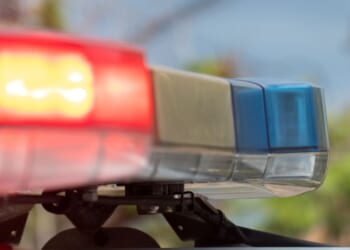 Emergency lights on a police vehicle flash.