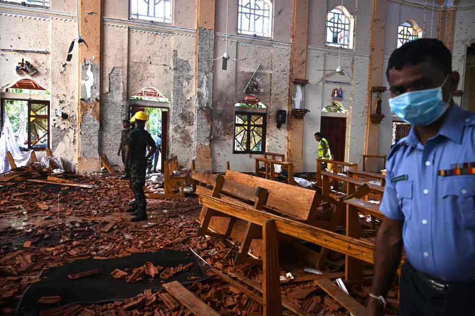 Security personnel inspect the bomb-damaged interior of St Sebastian's Church in Negombo, Sri Lanka.