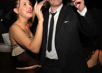 Millie Bobby Brown and David Harbour have been accused of performing an 'OTT comedy double act for the cameras' by a body language expert as the pair put on a bizarre display at the Stranger Things party on Thursday