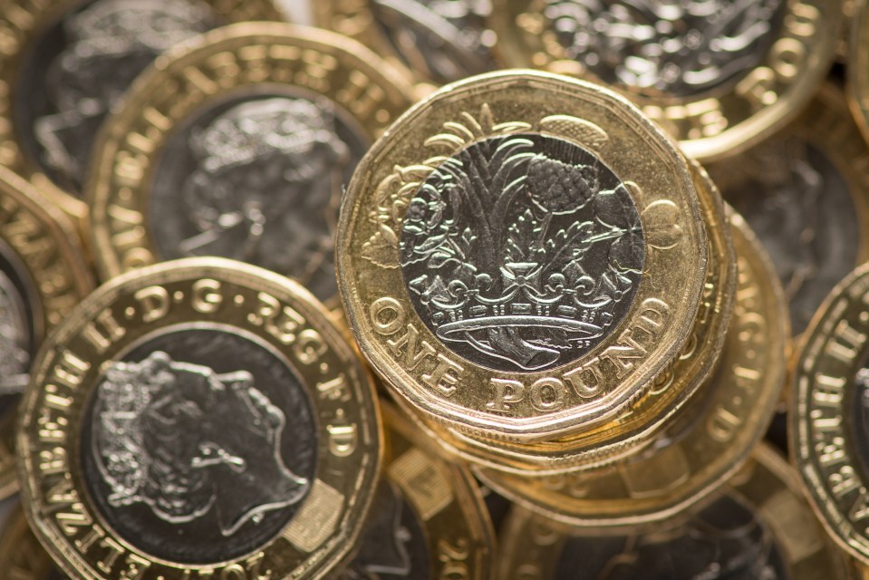 Close-up of a stack of British one-pound coins.