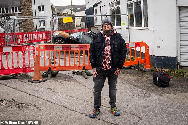 A neighbour told owner, Malcolm McKenzie about his car - where he found it trapped in a hole with the bonnet raised a foot in the air