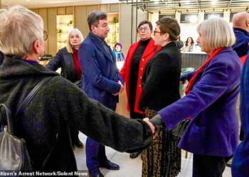 Footage shows businessman Lawrence Gosden surrounded by hand-holding anti-pollution protesters as he makes his way to a conference in London