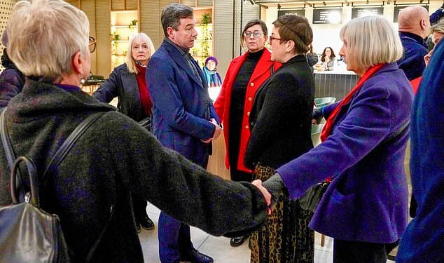 Footage shows businessman Lawrence Gosden surrounded by hand-holding anti-pollution protesters as he makes his way to a conference in London