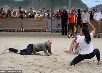 The Prince of Wales takes part in a game of volleyball with players from thee Levante Institute, a local beach volleyball school, at Copacabana Beach in Rio de Janeiro