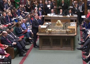 Ms Reeves can be seen looking at Torsten Bell's phone while Sir Keir Starmer is speaking