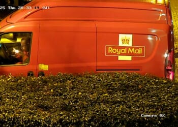 A postman has been stood down after he was caught smoking a drugs pipe while sat in his red van