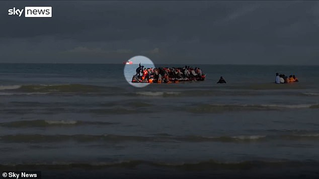 A suspected people smuggler was caught on video pretending to fall off a small boat to evade suspicion from French police