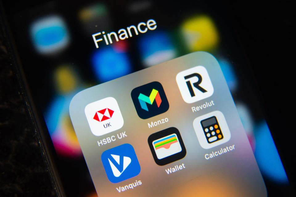 Smartphone screen displaying finance and banking apps: HSBC UK, Monzo, Revolut, Vanquis, Wallet, and Calculator.