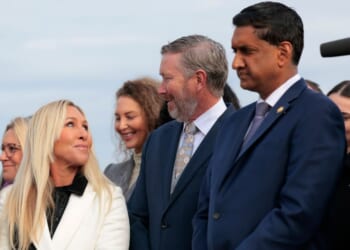 Rep. Marjorie Taylor Greene of Georgia speaks with fellow GOP Rep. Thomas Massie of Kentucky, center, and Democratic Rep. Ro Khanna of California in Washington, D.C.