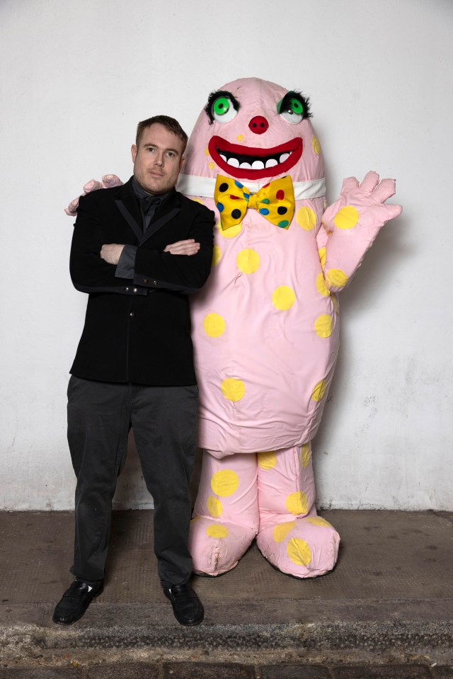 Joseph Cook in a black suit with his Mr Blobby tribute costume.