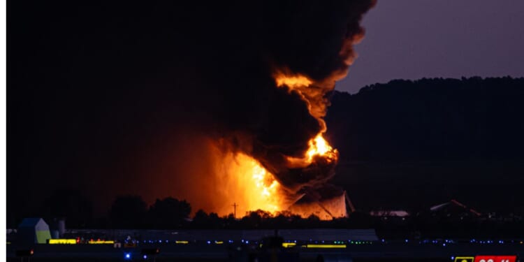 A fireball erupts near airport property after a plane crash at Louisville International Airport Tuesday in Louisville, Kentucky.