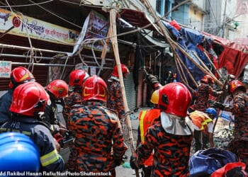 Fire service personnel work at the scene after at least three people are reported dead on the spot when the railing of the rooftop of a five-storey building collapses following an earthquake in the Kosaituli area of Armanitola in Dhaka, Bangladesh, on November 21, 2025