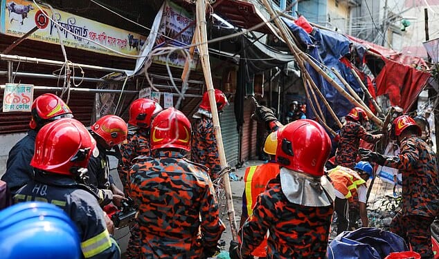 Fire service personnel work at the scene after at least three people are reported dead on the spot when the railing of the rooftop of a five-storey building collapses following an earthquake in the Kosaituli area of Armanitola in Dhaka, Bangladesh, on November 21, 2025