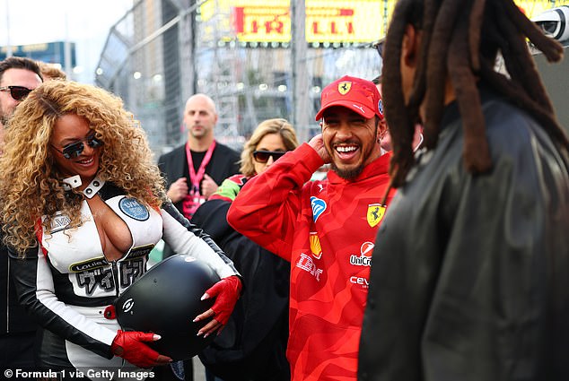 Beyonce at the F1 Las Vegas Grand Prix in a Louis Vuitton leather racing suit snapped alongside Lewis Hamilton