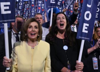 Former House Speaker Nancy Pelosi, left, and her daughter Christine Pelosi hold "We Love Joe" signs in a file photo from Aug. 19, 2024, as then-President Joe Biden spoke on the first day of the Democratic National Convention in Chicago, Illinois.