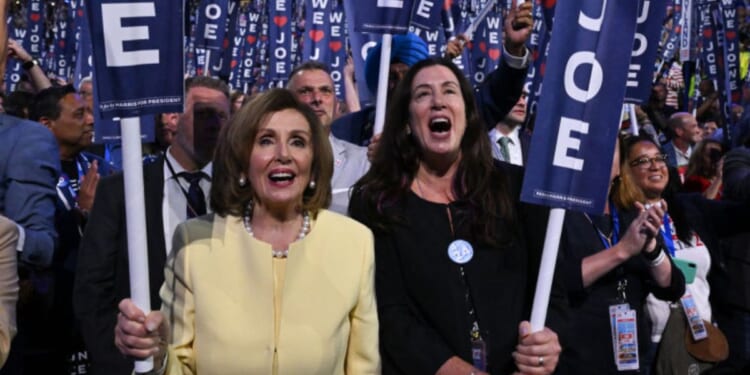 Former House Speaker Nancy Pelosi, left, and her daughter Christine Pelosi hold "We Love Joe" signs in a file photo from Aug. 19, 2024, as then-President Joe Biden spoke on the first day of the Democratic National Convention in Chicago, Illinois.